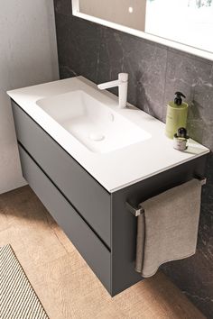 a white sink sitting on top of a bathroom counter