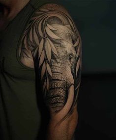 an elephant tattoo on the arm and shoulder