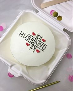 a cake with the words husband and wife on it in a plastic container next to some confetti