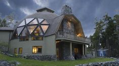 a large house with a glass roof in the evening