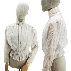 "Antique French blouse in batiste, Edwardian era shirt with white embroideries and lace, early 1900s-woman white blouse with high collar. MEASUREMENTS: Max length 24\" (61 cm), chest width ca 20\" (50.8 cm). DESCRIPTION: Wonderful antique blouse or shirt for woman, French origin, in white cotton batiste, dating circa to 1910. The shirt has embroidered flowers with openwork details on the front and on the sleeves and lace inserts, high neck collar and closure with mop buttons. HOW TO USE IT: Prec Victorian White Blouse With Lace Collar, White Victorian Blouse With Lace Collar, Victorian Blouse With Lace Collar, Victorian Blouse With Lace Collar For Daywear, White Victorian Style Top With Lace Work, High Neck White Blouse, Edwardian Shirtwaist, French Blouse, Edwardian Blouse