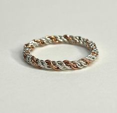 A handmade/handcrafted pure sterling silver and copper ring, made of braided silver and copper wire. The thickness of the actual band ranges from 2.3-2.6mm approximately. Because of the design, this ring cannot be re-sized.  Ring size: 9 Weight: 1.73 grams  If you're interested in having one made to order in another size, send us a message. Silver Braided Ring, Braided Ring, Copper Ring, Copper Rings, Rings Statement, Copper Wire, Statement Rings, Jewelry Rings, Braids