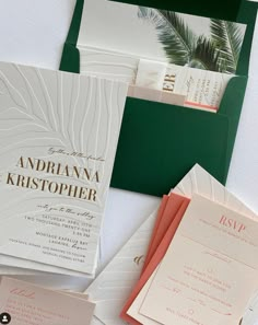 the wedding stationery is laid out on top of each other