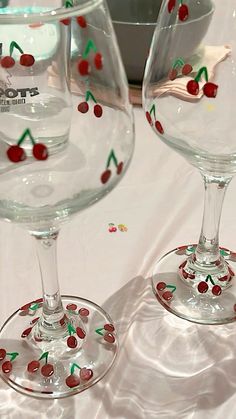 two wine glasses with cherries painted on them