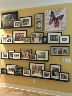 a wall filled with lots of framed pictures