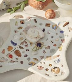 there is a decorative tray with shells on it