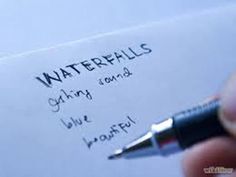 a hand holding a pen over a piece of paper with writing on it that says waterfells