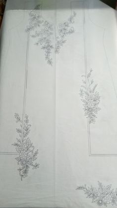 the table cloth has been embroidered with flowers