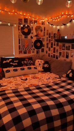 a bed room with a neatly made bed and lots of pictures on the wall