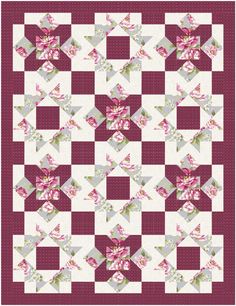 a quilt with pink and white flowers on it