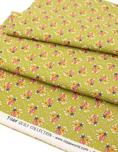 two pieces of green fabric with flowers on them