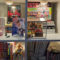 there are many books and toys on the shelves in this room, all stacked together