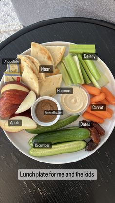 a white plate topped with lots of different types of food on top of a table