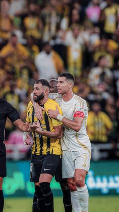 two soccer players colliding with each other in front of an audience at a game