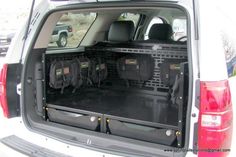 the back end of a white van with its cargo compartment open