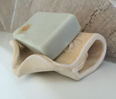 a soap bar sitting on top of a wooden holder