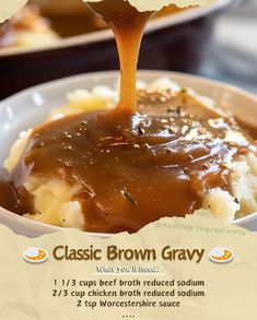 a spoon is pouring gravy over mashed potatoes