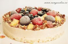 a cake topped with fruit and nuts on top of a white plate