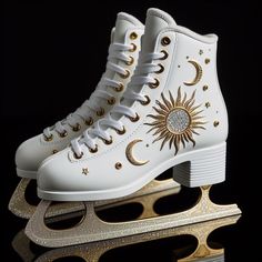 a pair of white ice skates with gold accents