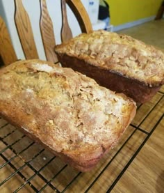 two loaves of bread cooling on a rack