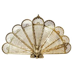 a gold fan shaped object on a white background