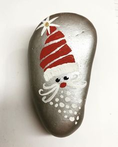 a rock with a santa clause painted on it's face is shown in the middle of an instagram post