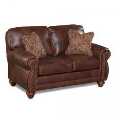 a brown leather couch with studding on the arms