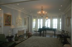 a living room filled with furniture and a grand piano