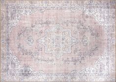 an old, faded rug is shown in grey and beige tones with intricate designs on the edges