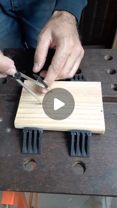 a man is using scissors to cut wood