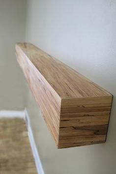 a wooden shelf sitting on the side of a wall