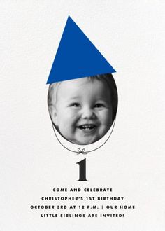 a blue birthday card with a photo of a smiling child in a cone on it