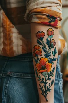 a woman with a flower tattoo on her arm