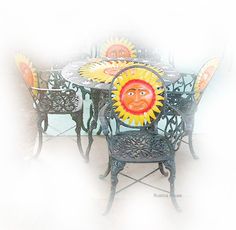 the table and chairs are decorated with sunflowers