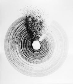 an abstract black and white photo with ink sprinkles in the shape of a circle