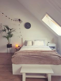 there is a bed in the room with a skylight above it