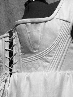 the back of a white corset on a mannequin