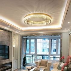 a living room filled with furniture and a flat screen tv mounted on the wall next to a fire place