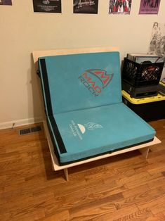 a blue couch sitting on top of a hard wood floor