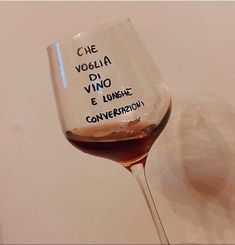 a wine glass with some writing on it