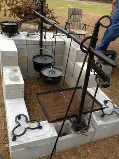 an image of some buckets in the middle of a cement block with chains on it