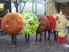 four people in costumes made to look like hamburgers