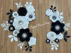 paper flowers are arranged on the floor in black and white colors, with one large flower surrounded by smaller ones