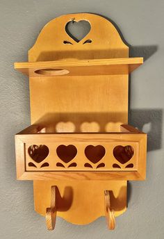 a wooden shelf with two hearts on it