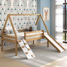 a child's bed with a slide in front of it and a wallpapered background