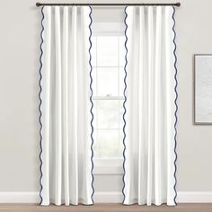 white curtains with blue trims in front of a window