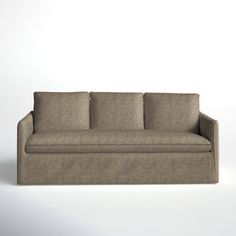 a beige couch sitting on top of a white floor