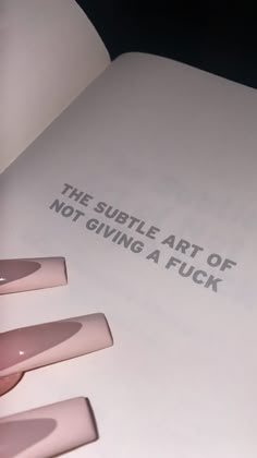 an open book with writing on it that says the subtle art of not giving a fock