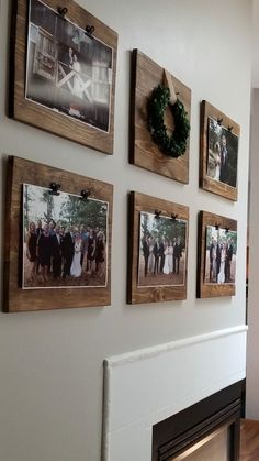 the wall is decorated with pictures and wreaths on it's sides, along with a fireplace mantel