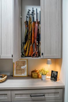 Concealed behind a cabinet door, the gun storage in this hunting room offers secure and discreet protection for firearms, ensuring the safety and peace-of-mind for the homeowner. Hunting Gear Closet, Home Armory, Hunting Closet, Armory Room, Tuscaloosa Alabama, Utility Closet, Country Squire